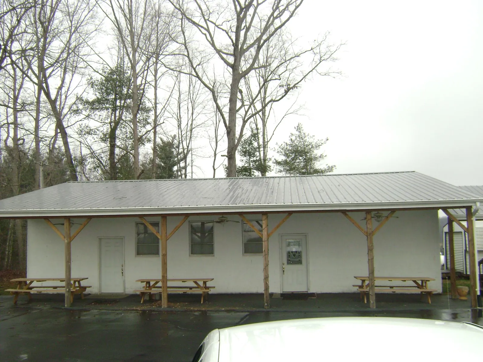 Gray metal roof over a block building with a timber post porch in Berkeley Heights